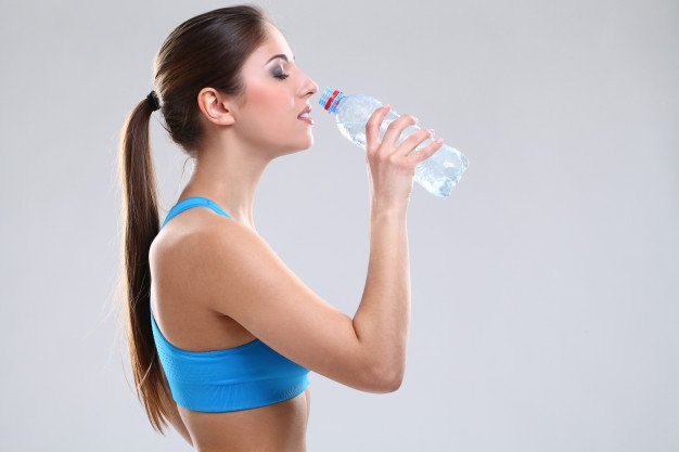 beautiful-Caucasian-woman-fitwear-drinking-water-hydrating-her-body