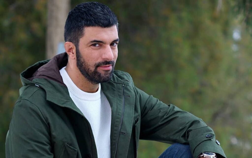 Engin Akyurek in white tee short hair turkish actor